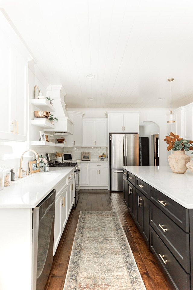 9405 Peppy Branch Trl, Apison, TN 37302 - kitchen featuring appliances with stainless steel finishes, open shelves, white cabinets, arched walkways, and dark wood-type flooring