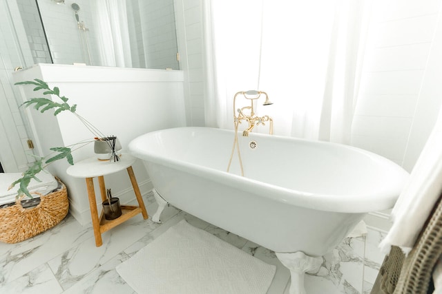 9405 Peppy Branch Trl, Apison, TN 37302 - bathroom featuring marble look tiles, a freestanding bath, and baseboards