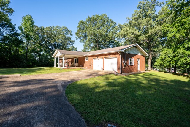 1106 Browns Ferry Rd, Chattanooga, TN 37419 - view of front of house featuring a porch, driveway, a front yard, a garage, and brick siding