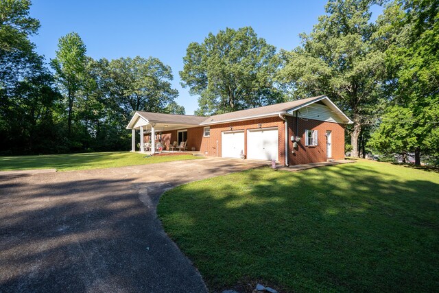 1106 Browns Ferry Rd, Chattanooga, TN 37419 - view of front facade featuring covered porch, an attached garage, driveway, a front lawn, and brick siding