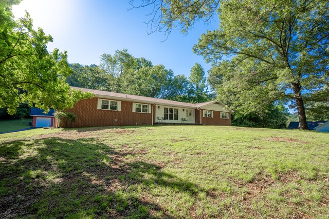 1106 Browns Ferry Rd, Chattanooga, TN 37419 - rear view of house featuring brick siding and a yard