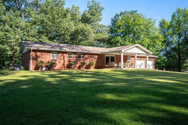 1106 Browns Ferry Rd, Chattanooga, TN 37419 - single story home with a front lawn, a garage, brick siding, and a porch