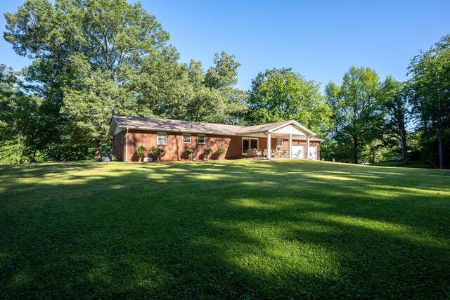 1106 Browns Ferry Rd, Chattanooga, TN 37419 - view of front facade featuring a front yard, a garage, a porch, and brick siding