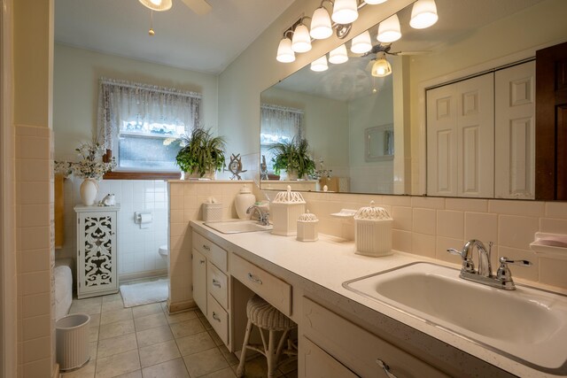 1106 Browns Ferry Rd, Chattanooga, TN 37419 - bathroom featuring a ceiling fan, tile patterned flooring, tile walls, and double vanity