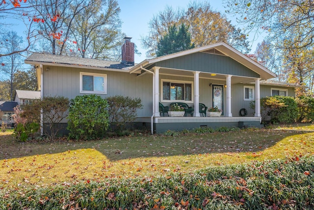 1616 Crappie Cir, Soddy Daisy, TN 37379 - view of front facade featuring a chimney, a porch, a front lawn, and crawl space