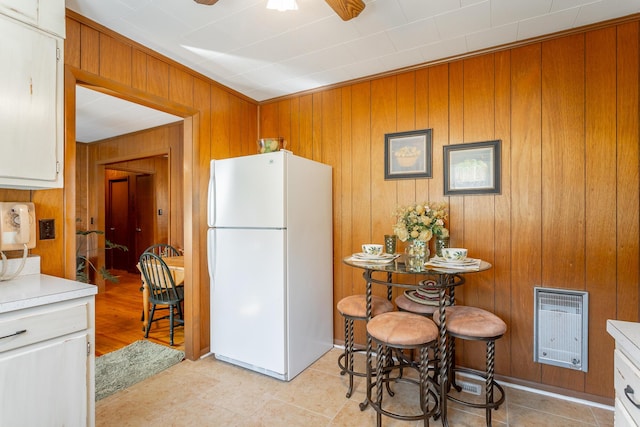 1616 Crappie Cir, Soddy Daisy, TN 37379 - kitchen with freestanding refrigerator, wood walls, light countertops, a ceiling fan, and heating unit