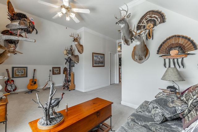 living area featuring a ceiling fan, carpet flooring, baseboards, and crown molding