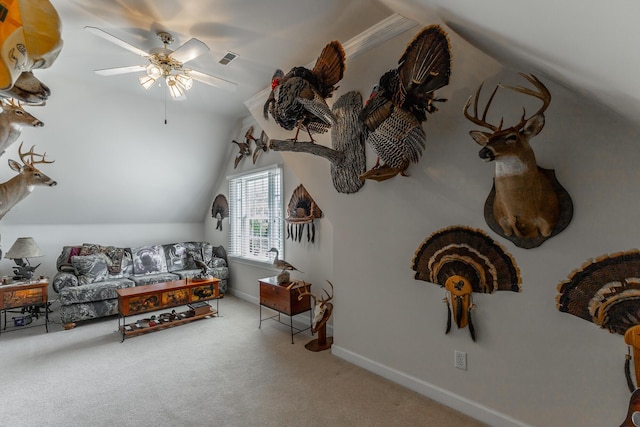 carpeted living area featuring a ceiling fan, lofted ceiling, and baseboards