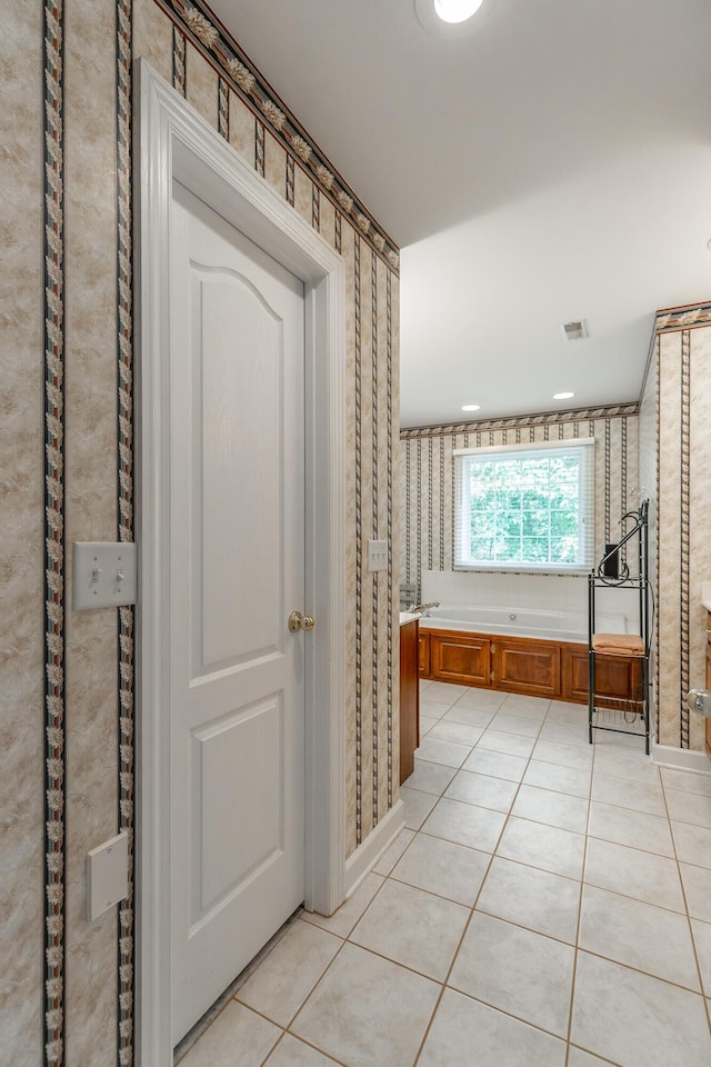 full bath featuring wallpapered walls, tile patterned floors, and a garden tub