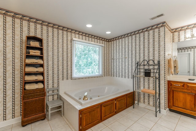 bathroom with wallpapered walls, tile patterned flooring, a whirlpool tub, vanity, and baseboards