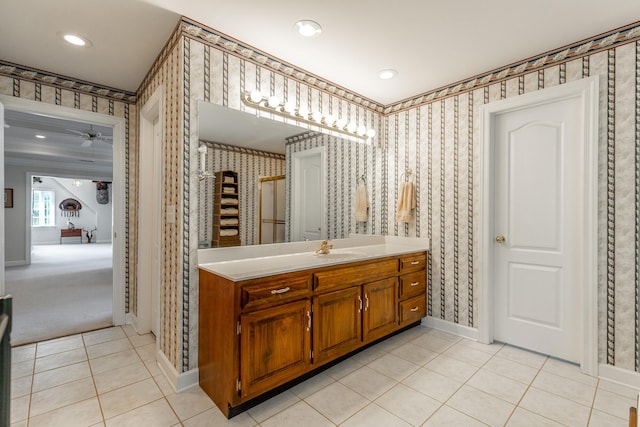 full bathroom featuring wallpapered walls, tile patterned flooring, baseboards, vanity, and recessed lighting