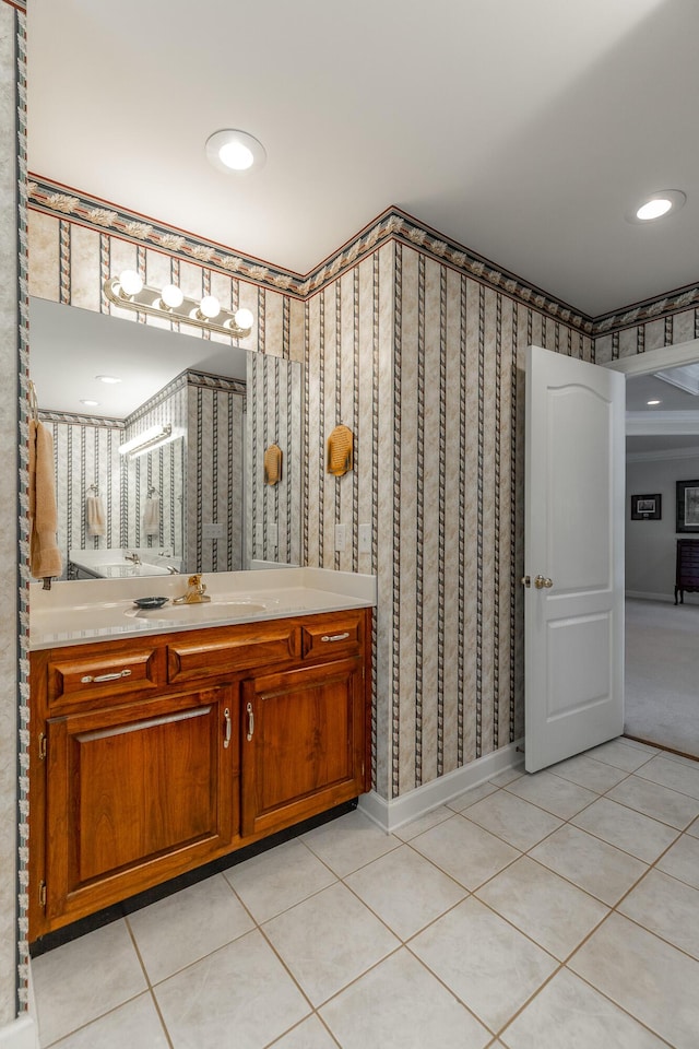 bathroom featuring tile patterned floors, wallpapered walls, vanity, and baseboards