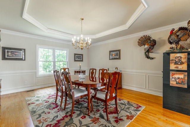 2023 Bay Pointe Dr, Hixson, TN 37343 - dining space with a raised ceiling, a chandelier, light wood-style flooring, ornamental molding, and a wainscoted wall