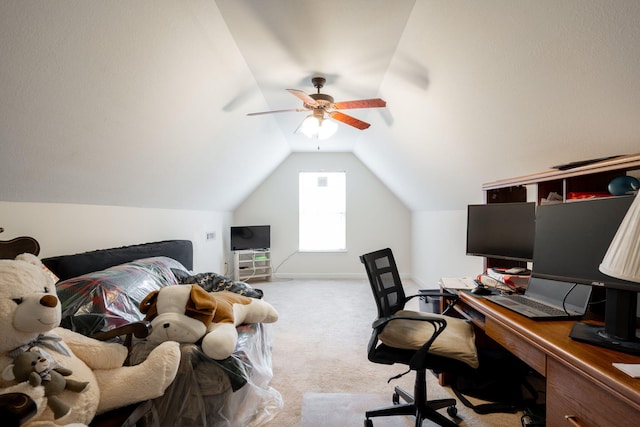 office area with carpet flooring, vaulted ceiling, and a ceiling fan