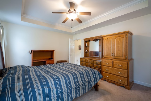 bedroom featuring crown molding, light colored carpet, a raised ceiling, a ceiling fan, and baseboards