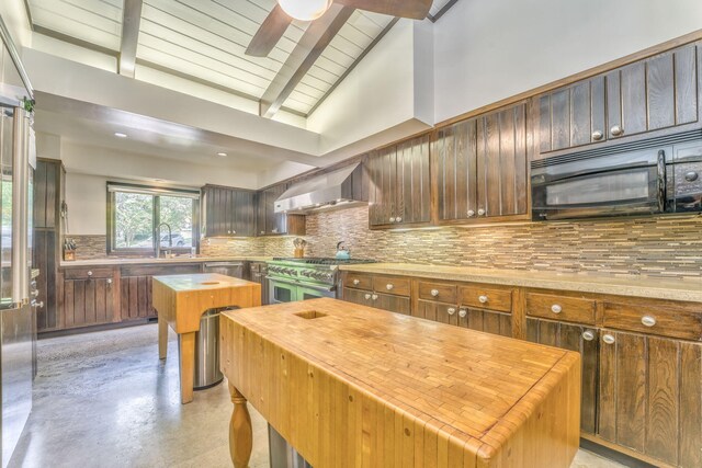 1301 W Morton Dr, Dalton, GA 30720 - kitchen with wall chimney exhaust hood, butcher block counters, appliances with stainless steel finishes, and tasteful backsplash