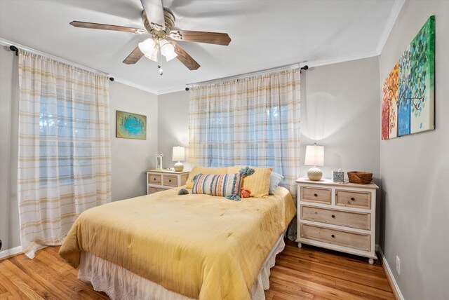 1123 Ridgeleigh Cir, Dalton, GA 30720 - bedroom featuring crown molding, wood finished floors, baseboards, and a ceiling fan