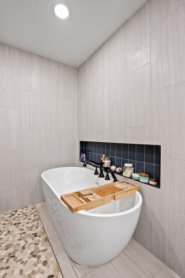 1123 Ridgeleigh Cir, Dalton, GA 30720 - bathroom featuring a freestanding bath and tile walls