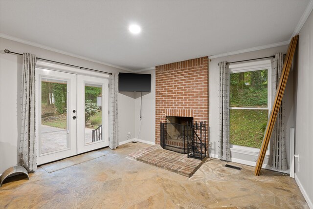 1123 Ridgeleigh Cir, Dalton, GA 30720 - unfurnished living room featuring stone flooring, french doors, ornamental molding, a brick fireplace, and baseboards