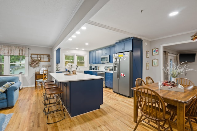 1123 Ridgeleigh Cir, Dalton, GA 30720 - kitchen with stainless steel appliances, blue cabinets, light countertops, recessed lighting, and light wood-style flooring