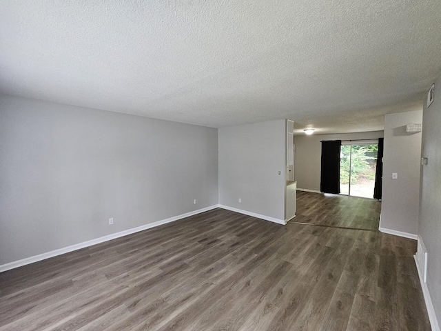 4458 Norcross Rd, Hixson, TN 37343 - spare room featuring a textured ceiling, wood finished floors, and baseboards