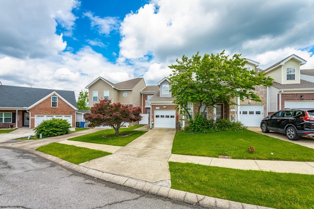7817 Legacy Park Ct, Chattanooga, TN 37421 - townhome / multi-family property with brick siding, concrete driveway, a front yard, and an attached garage