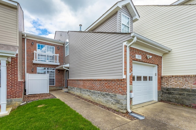 7817 Legacy Park Ct, Chattanooga, TN 37421 - view of side of home featuring brick siding, an attached garage, and driveway