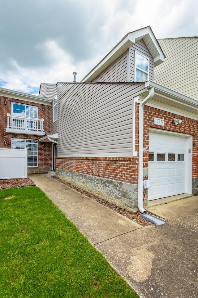 7817 Legacy Park Ct, Chattanooga, TN 37421 - view of side of property featuring a garage, brick siding, and driveway