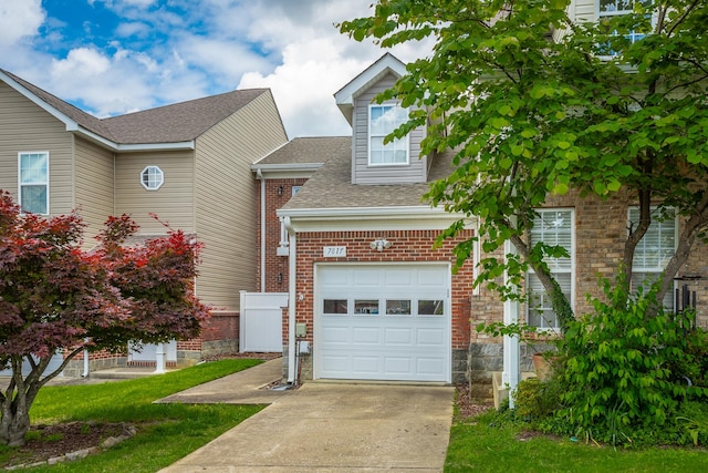 7817 Legacy Park Ct, Chattanooga, TN 37421 - view of front of house with roof with shingles, driveway, brick siding, and an attached garage