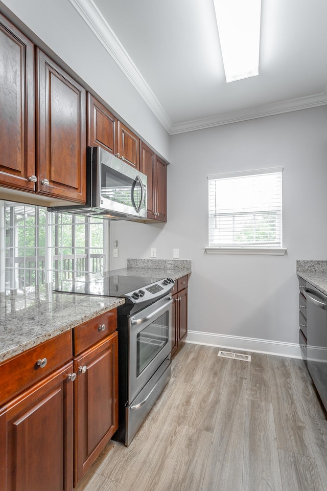 7817 Legacy Park Ct, Chattanooga, TN 37421 - kitchen with appliances with stainless steel finishes, light wood-style flooring, baseboards, healthy amount of natural light, and ornamental molding