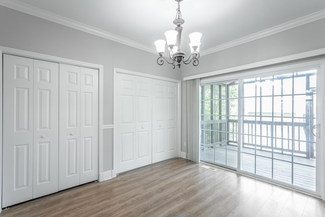 7817 Legacy Park Ct, Chattanooga, TN 37421 - unfurnished dining area with a chandelier, wood finished floors, and ornamental molding