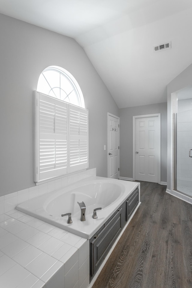 7817 Legacy Park Ct, Chattanooga, TN 37421 - full bathroom featuring vaulted ceiling, wood finished floors, a garden tub, and a shower stall