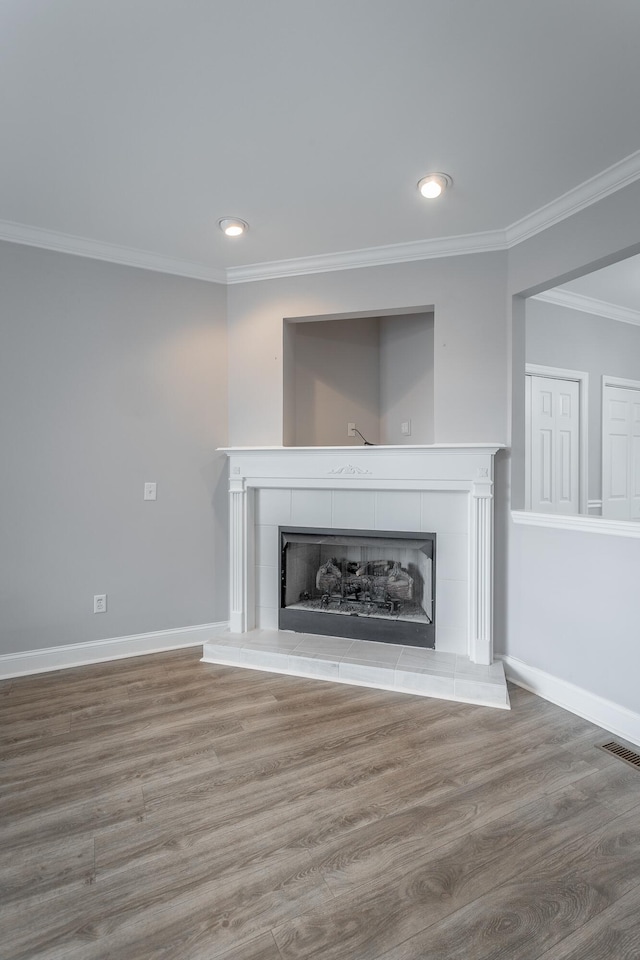7817 Legacy Park Ct, Chattanooga, TN 37421 - unfurnished living room featuring a tile fireplace, crown molding, wood finished floors, recessed lighting, and baseboards