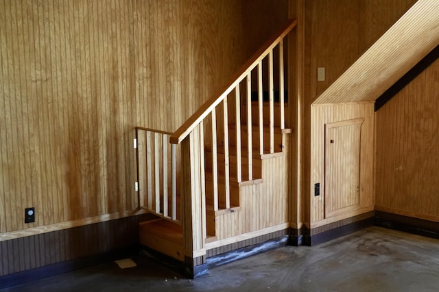 708 8th St, Bridgeport, AL 35740 - staircase featuring concrete flooring and wooden walls