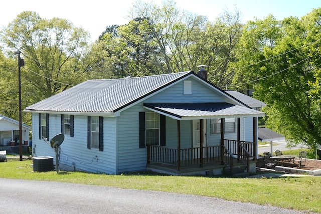 708 8th St, Bridgeport, AL 35740 - view of front of property featuring covered porch, metal roof, a chimney, and a front lawn