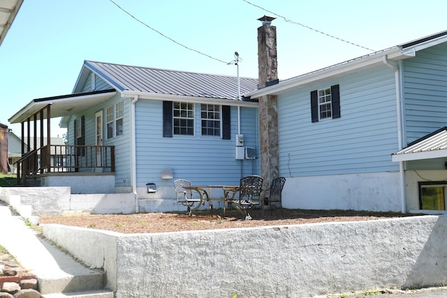 708 8th St, Bridgeport, AL 35740 - rear view of house with a chimney, a porch, and metal roof