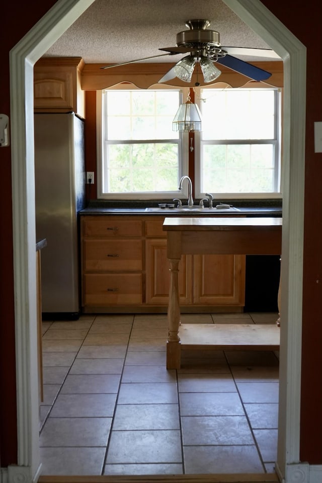 708 8th St, Bridgeport, AL 35740 - kitchen with freestanding refrigerator, a sink, healthy amount of natural light, and light tile patterned flooring