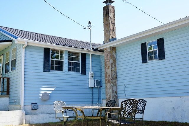 708 8th St, Bridgeport, AL 35740 - view of side of home featuring a chimney and metal roof