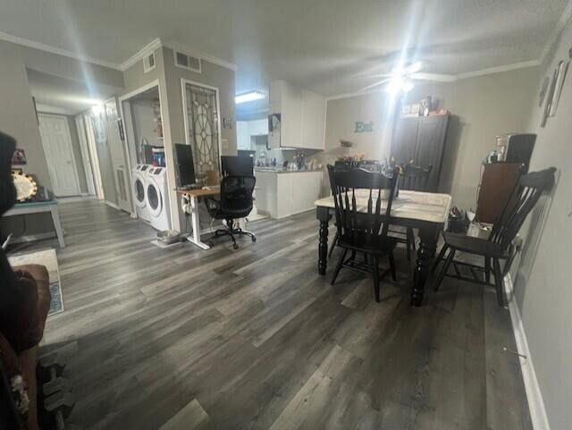 dining room with washing machine and clothes dryer, dark wood-style floors, crown molding, an office area, and baseboards