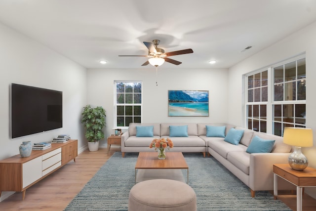 living room with a ceiling fan, light wood finished floors, baseboards, and recessed lighting