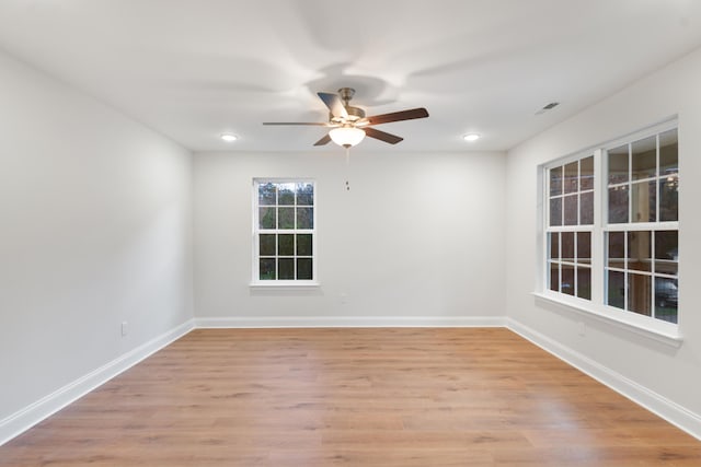 spare room with ceiling fan, light wood finished floors, baseboards, and recessed lighting