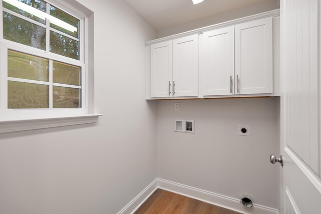 laundry room featuring electric dryer hookup, cabinet space, dark wood finished floors, baseboards, and washer hookup