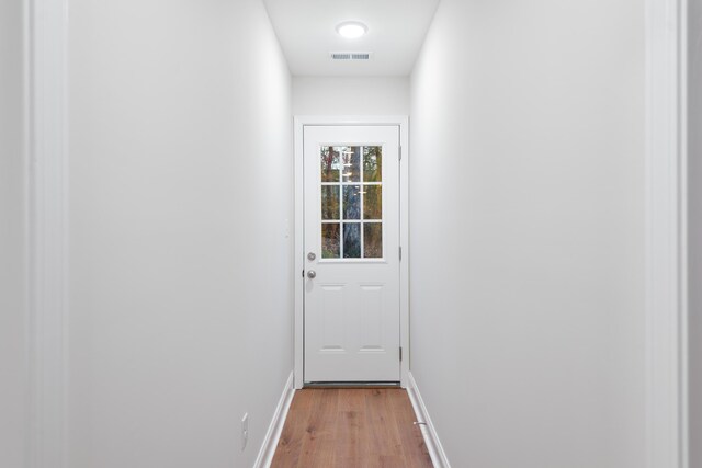 entryway featuring light wood finished floors and baseboards