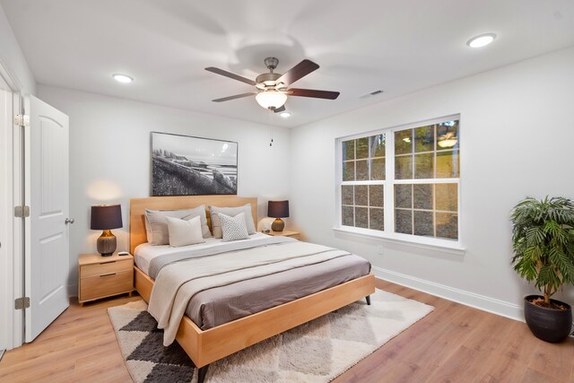 bedroom with light wood finished floors, baseboards, a ceiling fan, and recessed lighting
