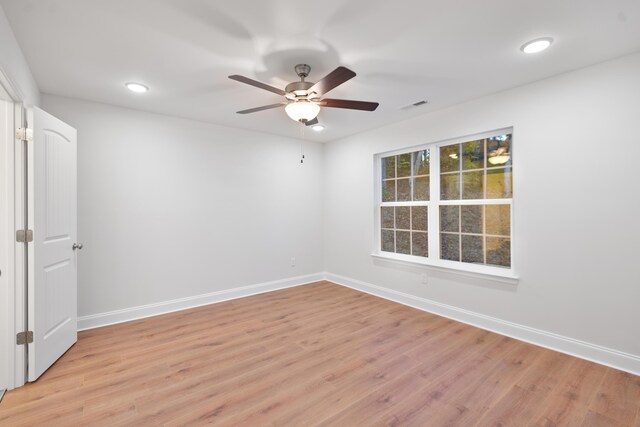 spare room featuring baseboards, light wood-style floors, ceiling fan, and recessed lighting