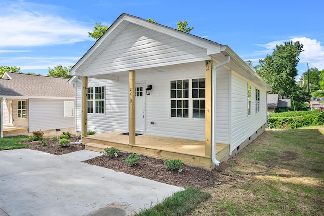view of front of house with crawl space and a patio area