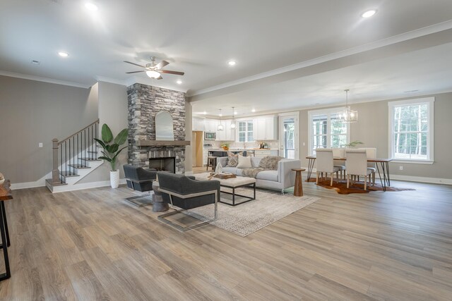 11570 Armstrong Rd, Soddy Daisy, TN 37379 - living area featuring crown molding, baseboards, stairway, light wood finished floors, and ceiling fan