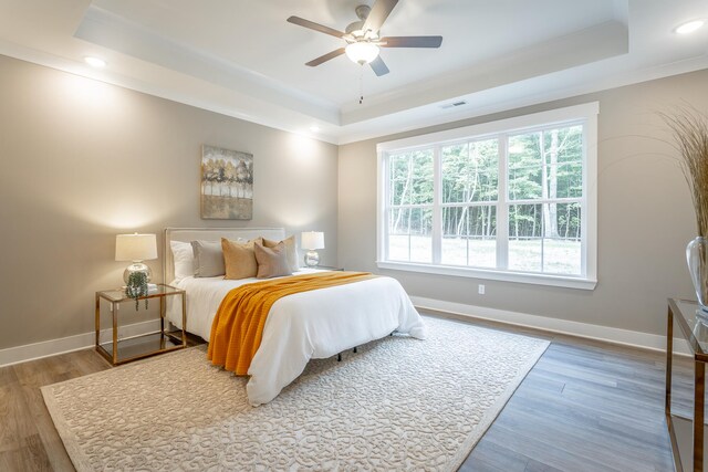 11570 Armstrong Rd, Soddy Daisy, TN 37379 - bedroom featuring a tray ceiling, crown molding, baseboards, wood finished floors, and recessed lighting