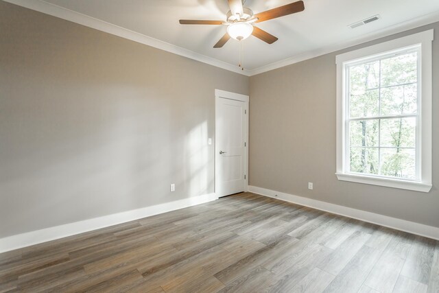 11570 Armstrong Rd, Soddy Daisy, TN 37379 - unfurnished room with healthy amount of natural light, wood finished floors, ceiling fan, baseboards, and ornamental molding