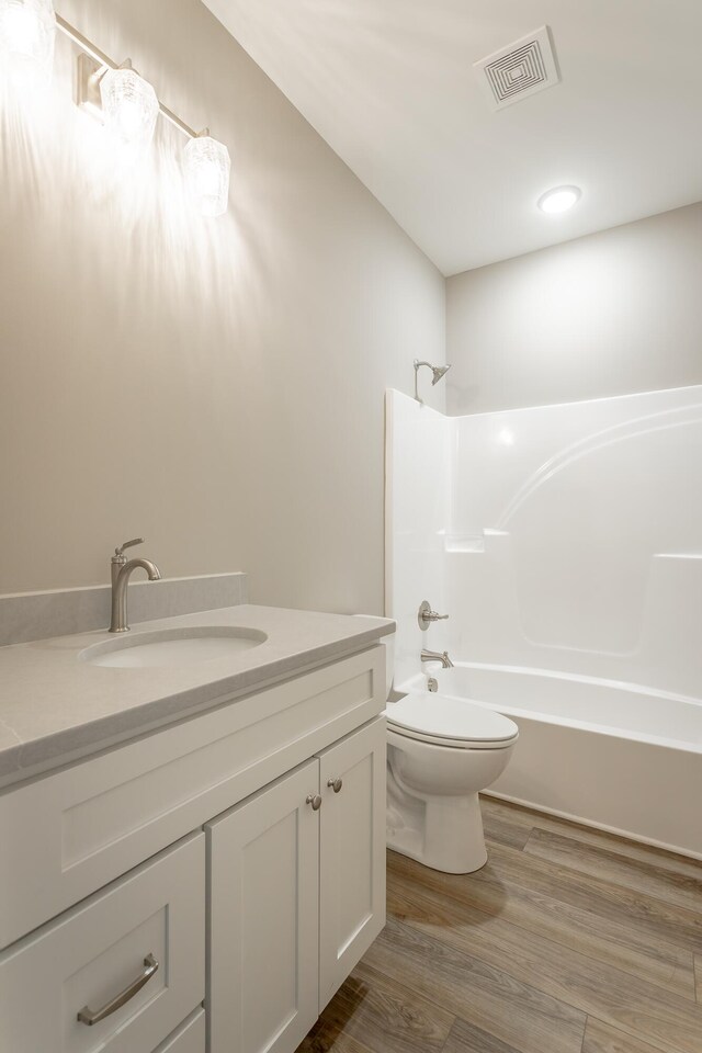 11570 Armstrong Rd, Soddy Daisy, TN 37379 - full bath with vanity,  shower combination, toilet, and wood finished floors